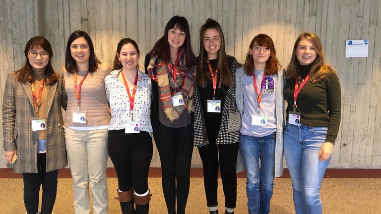 Members wearing their conference badges posing for a photo