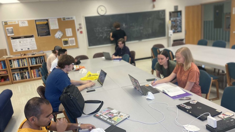 A scene of people working on homework